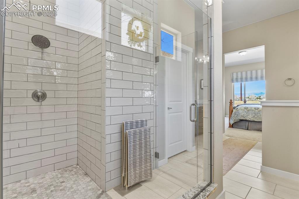 Image 23 of 50: Ensuite bathroom with a stall shower