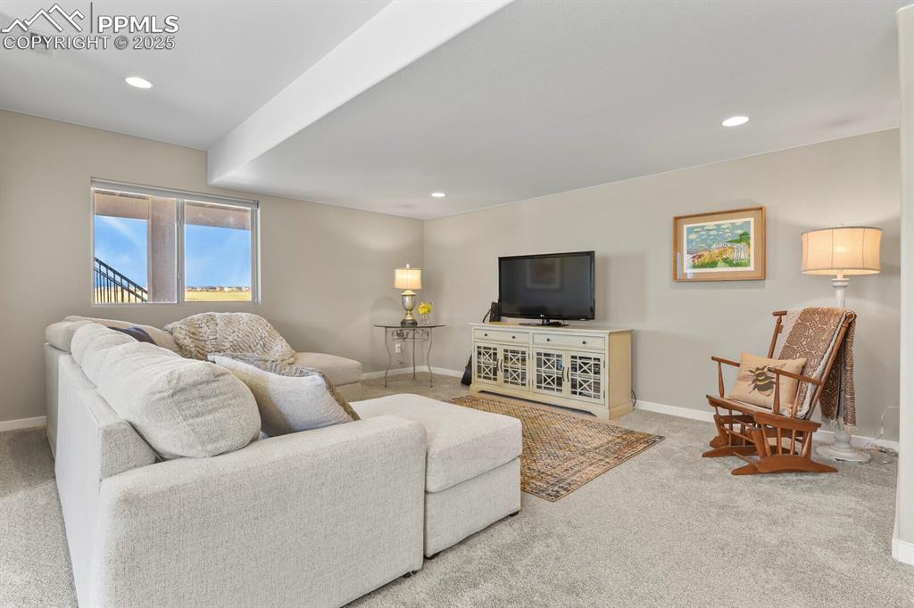 Image 35 of 50: Living area featuring light carpet and recessed lighting