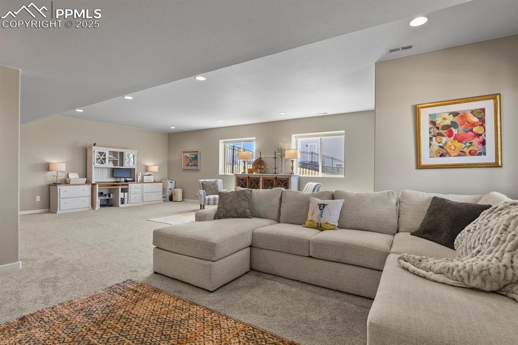 Image 37 of 50: Carpeted living room featuring recessed lighting and baseboards