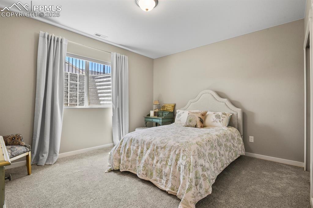Image 38 of 50: Carpeted bedroom with baseboards