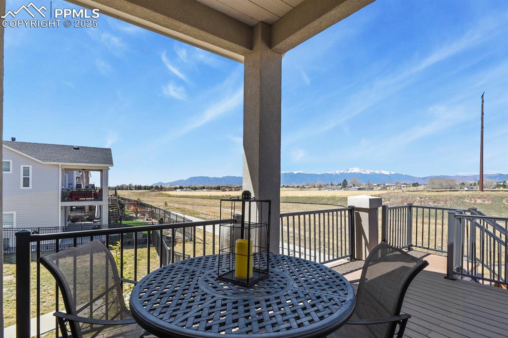 Image 44 of 50: Balcony featuring outdoor dining area, a mountain view, and a rural view