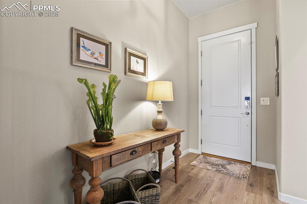 Image 5 of 50: Foyer entrance featuring wood finished floors and baseboards