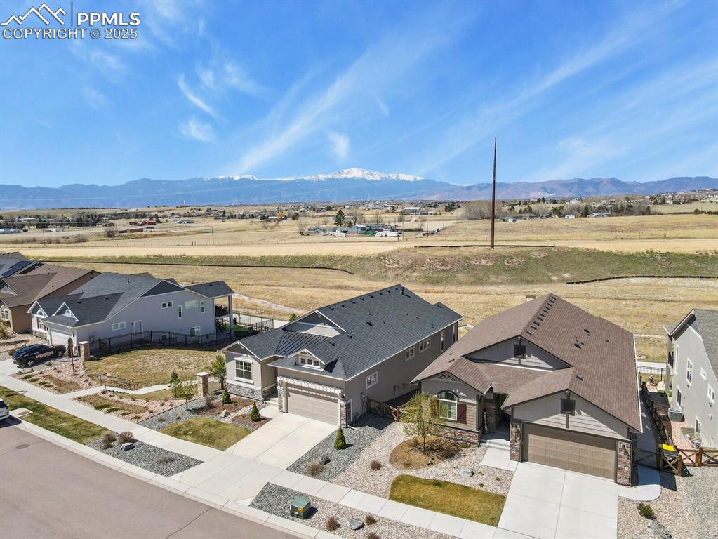 Image 50 of 50: Aerial perspective of suburban area with mountains