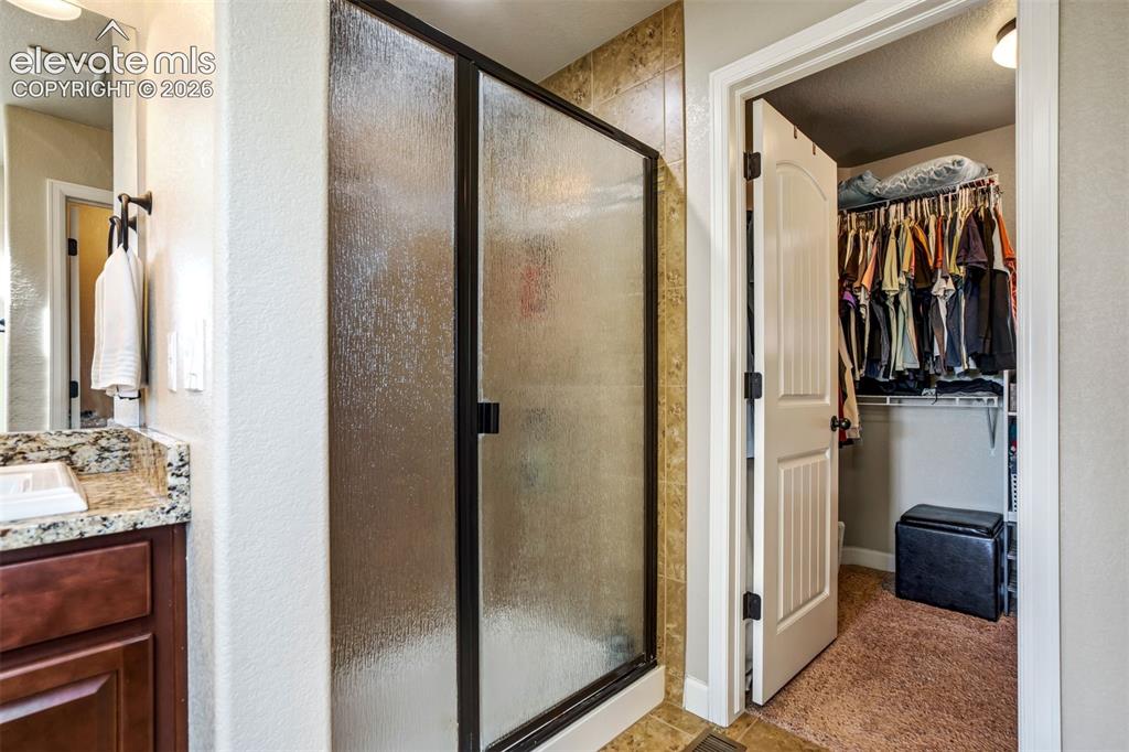 Image 25 of 47: Standing shower in addition to the soaking tub. 