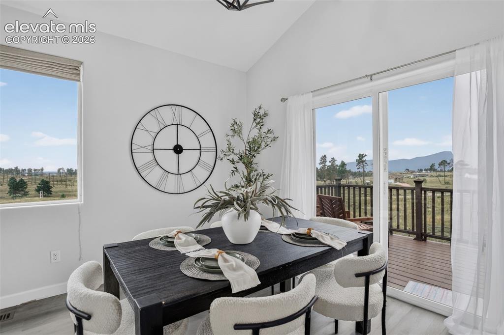Image 11 of 50: Dining area opens out to west facing deck.