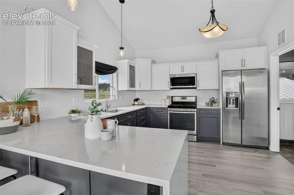 Image 13 of 50: Beautiful waterfall Quartz counter tops.