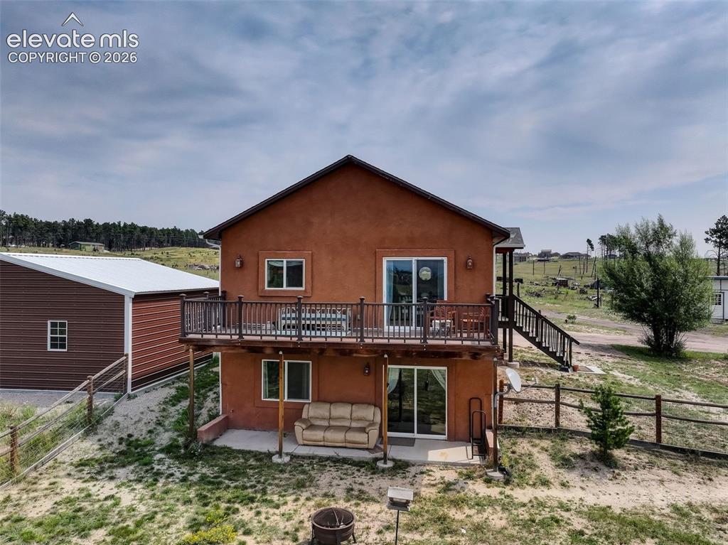 Image 45 of 50: West facing full size deck and covered patio Walk out basement and patio on