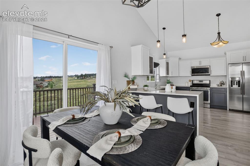 Image 9 of 50: Dining area opens up to west facing deck.