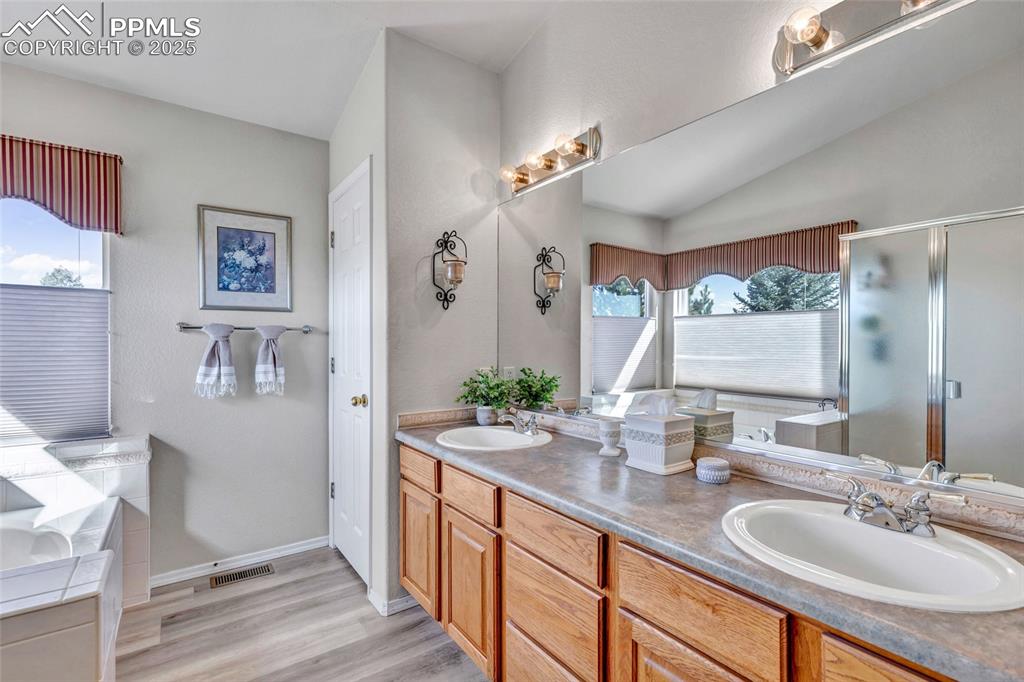 Image 16 of 23: Dual vanities, ample storage, and a clean palette that feels light and airy