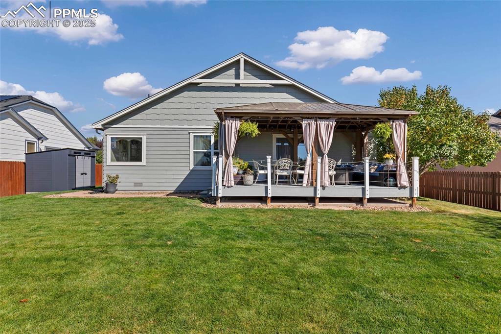 Image 22 of 23: Fully fenced and beautifully landscaped — the backyard you’ll never want to