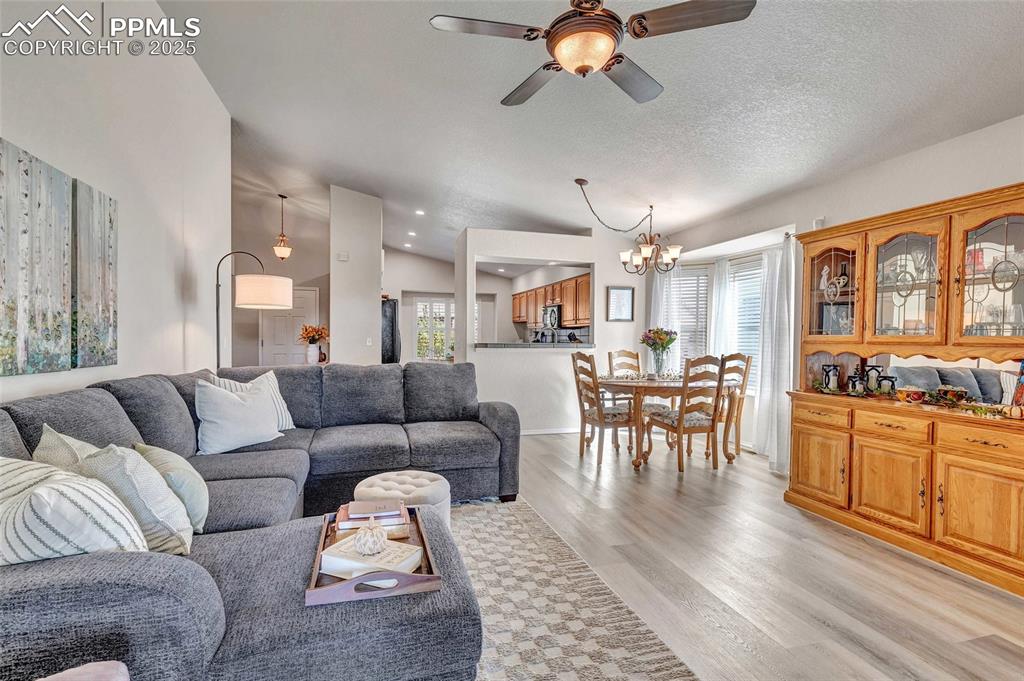 Image 4 of 23: Bright, open, and freshly updated with LVP flooring and vaulted ceilings — 