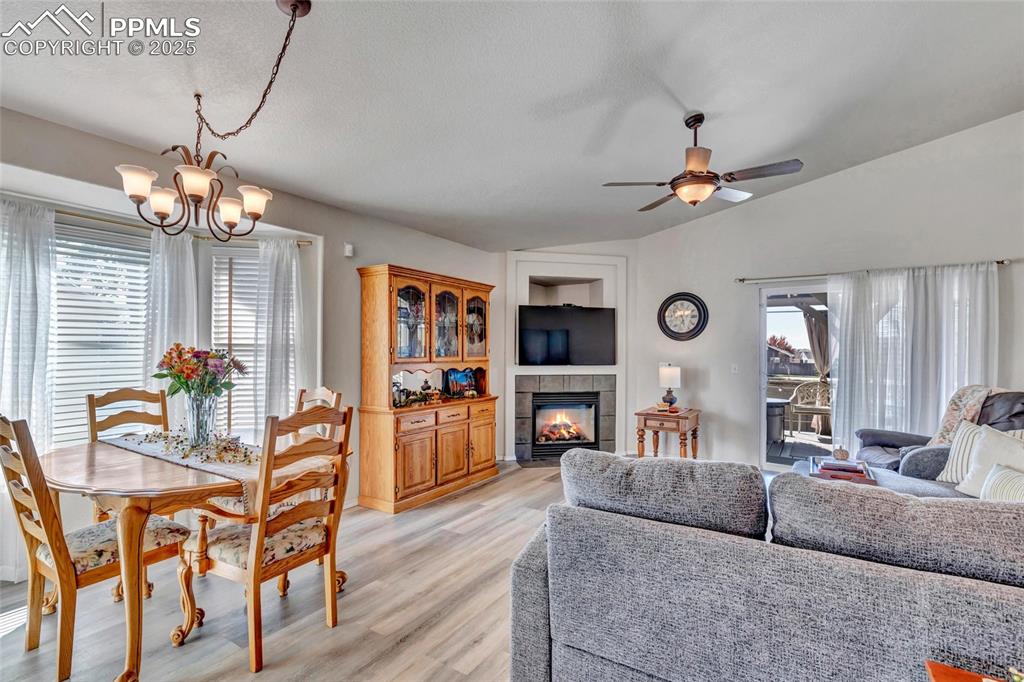 Image 5 of 23: Open-concept living with natural light pouring in and a cozy gas fireplace 