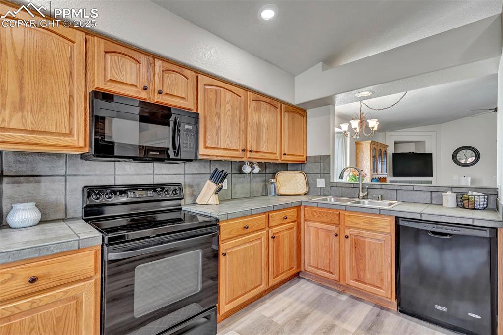 Image 8 of 23: Seamless sightlines to the living room — cook, host, and connect all at onc