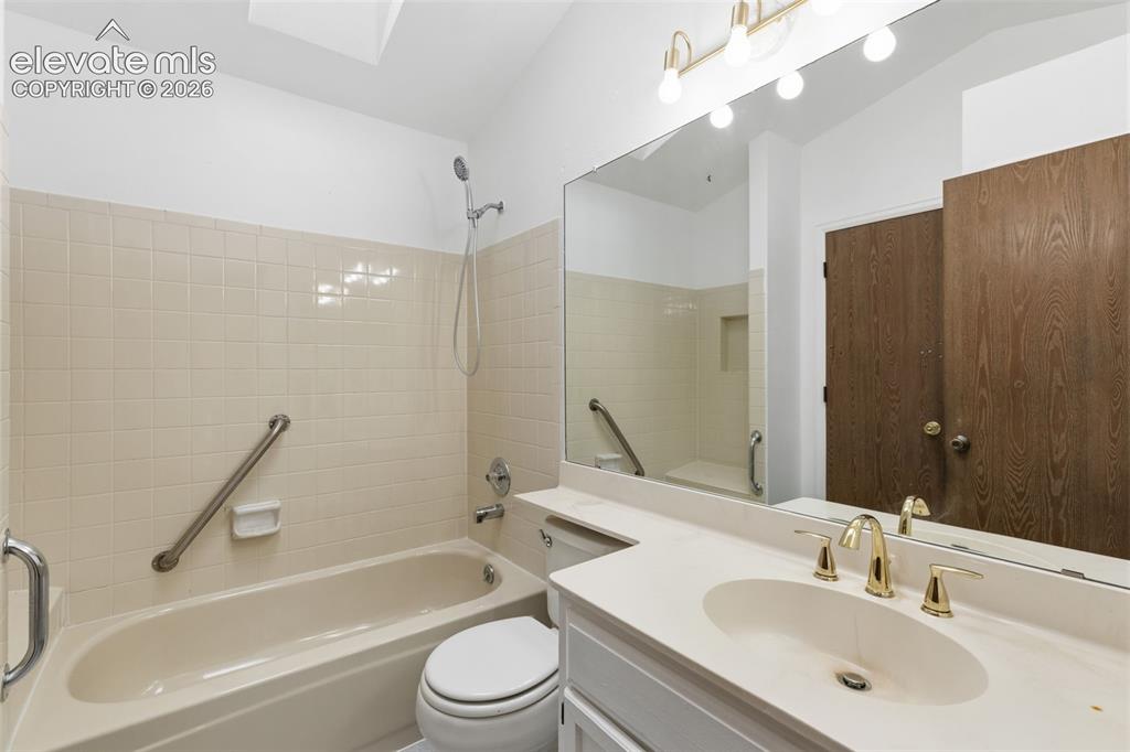 Image 36 of 43: Full bathroom featuring a single vanity with an integrated sink, gold-tone