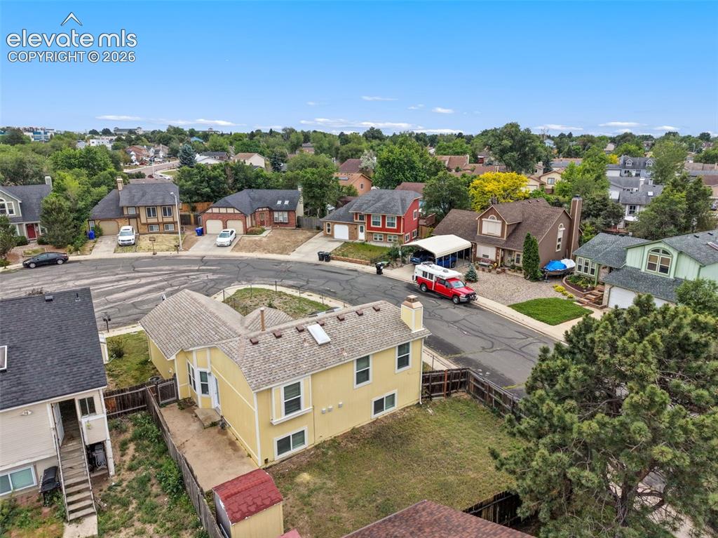 Image 4 of 43: Two-story residence with a light yellow exterior and a multi-level shingle