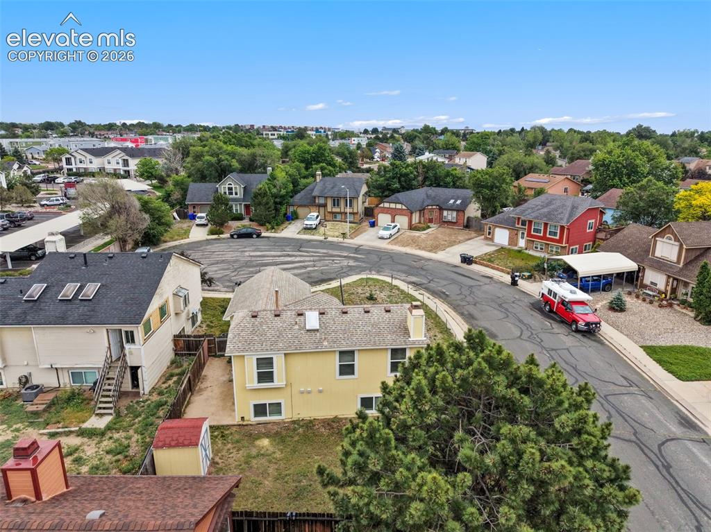 Image 5 of 43: Residential street featuring a variety of architectural styles, mature tree
