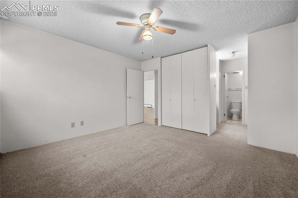 Image 17 of 33: Master bedroom wtih attached bath/shower.  His and hers closets