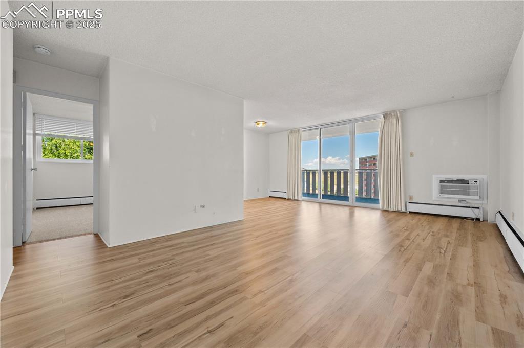 Image 2 of 14: Large open space with grand patio doors