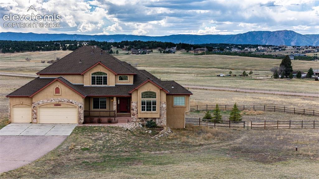 Image 2 of 47: See the fenced backyard? To the right is Rampart Range area in Pike Nationa