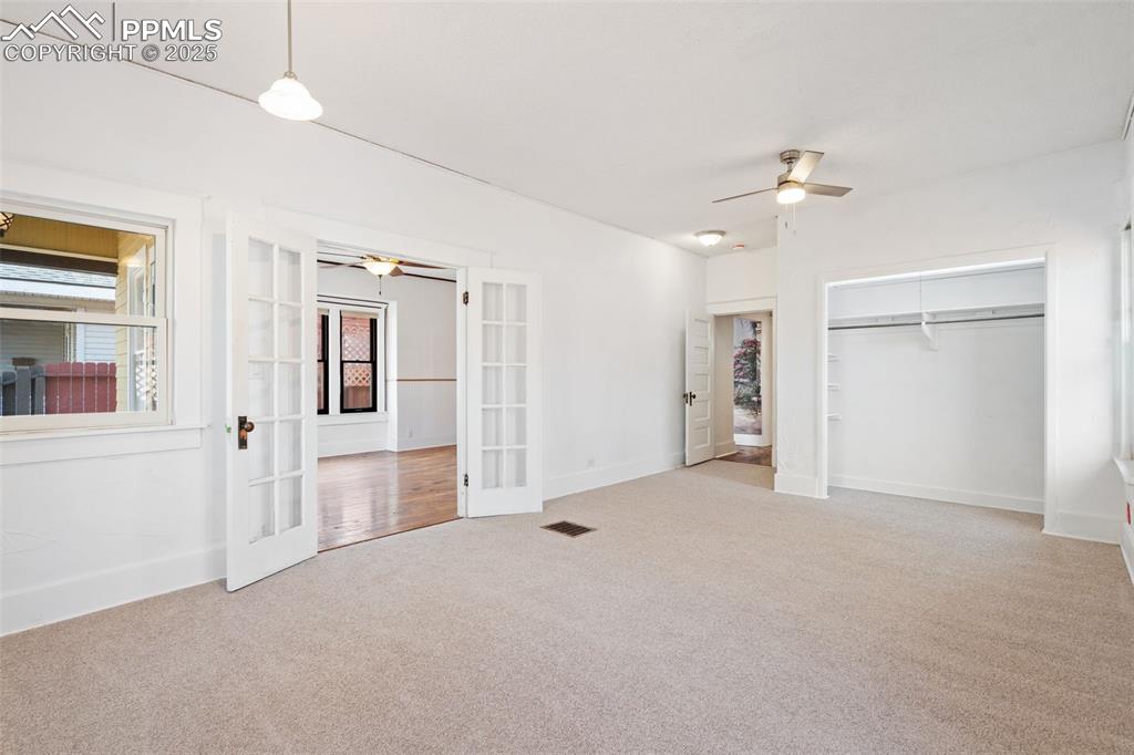Image 14 of 30: Large Primary Bedroom in Main home with Andersen windows. New Carpet 2025!
