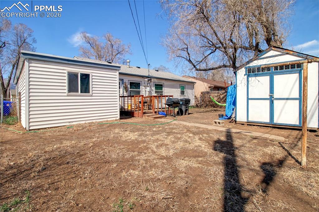 Image 20 of 21: Back of home with shed