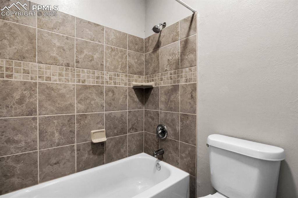 Image 15 of 28: Full bath with shower combination and toilet
