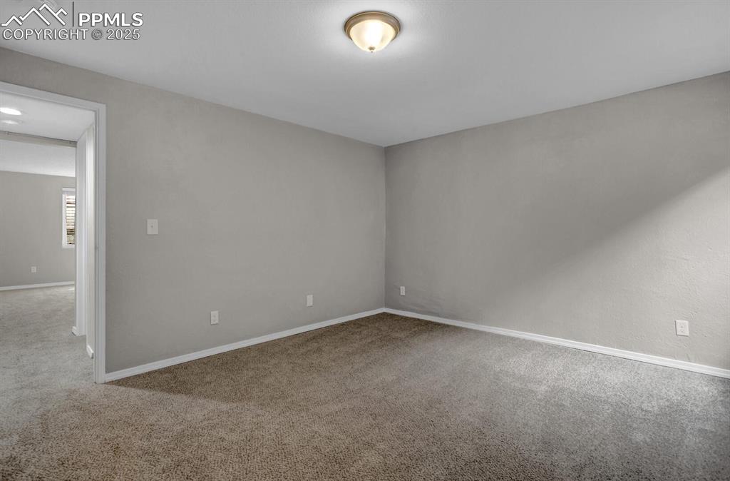 Image 22 of 28: Carpeted spare room featuring baseboards