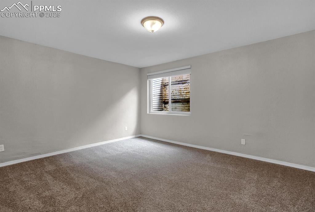 Image 24 of 28: Carpeted spare room featuring baseboards