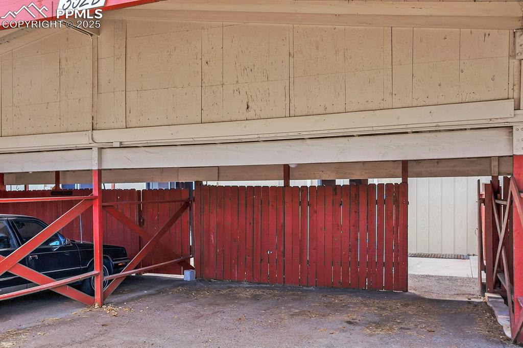 Image 28 of 28: Garage featuring fence