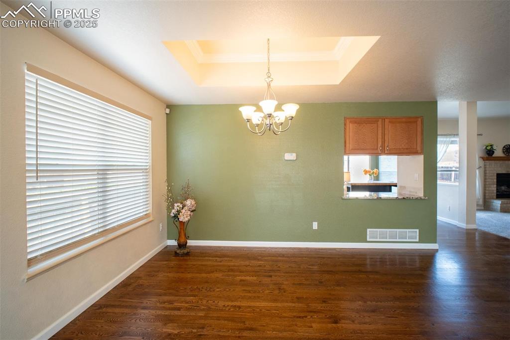 Image 3 of 37: The dining area has a pass through to the kitchen and views of the mountain