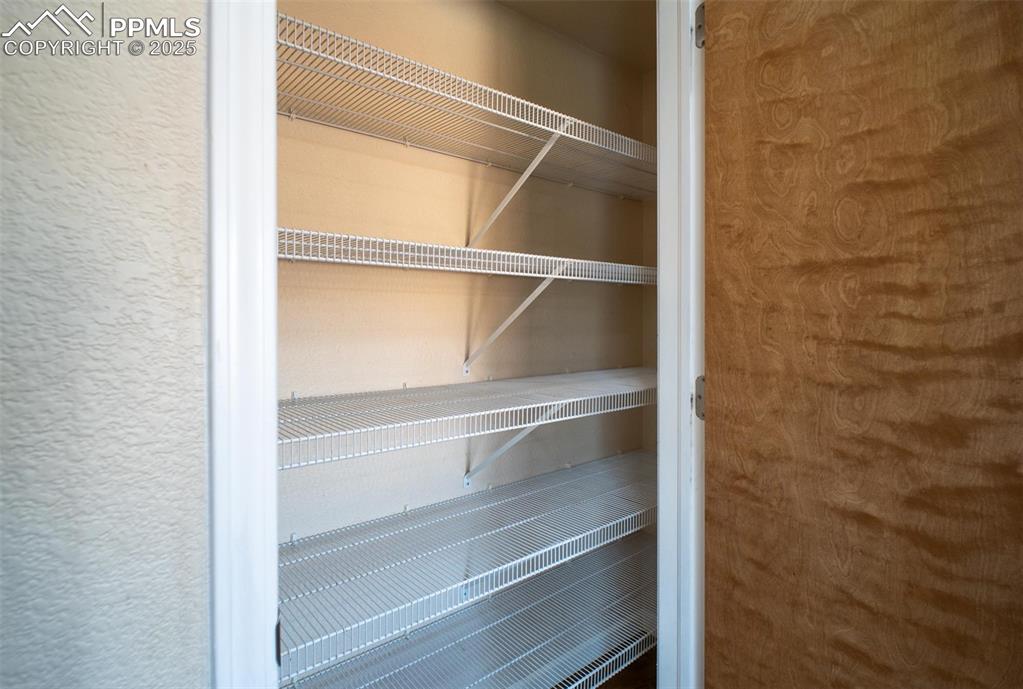 Image 9 of 37: A spacious pantry helps accommodate the bulk of food and appliances to free