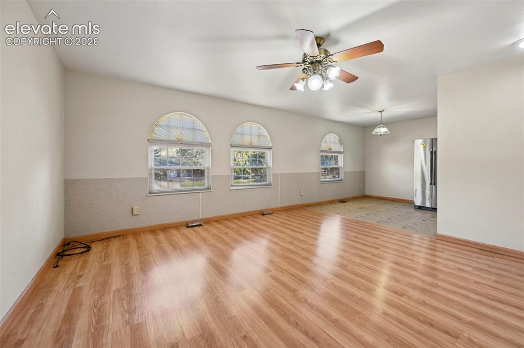 Image 11 of 50: Wood-finish flooring throughout the main living area, complemented by three