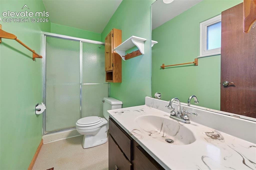 Image 22 of 50: Vanity with integrated sink, chrome faucet, and expansive mirror
