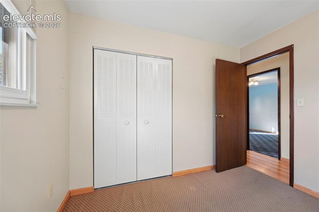 Image 24 of 50: Neutral wall color, window with natural light, bi-fold closet doors, wood t