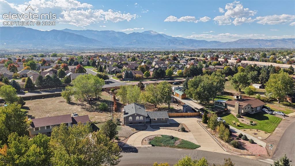 Image 46 of 50: Mountain range backdrop, residential area, mature trees, paved streets, cul