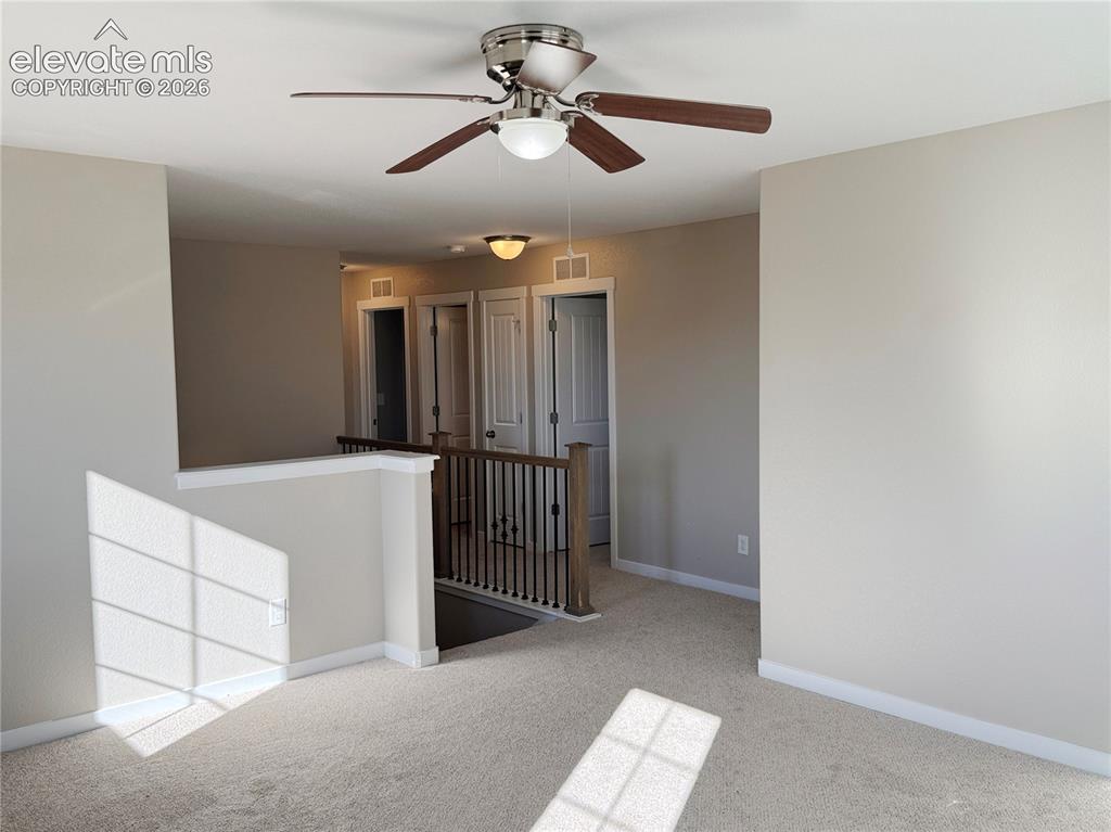 Image 21 of 42: Neutral-toned interior space featuring a five-blade ceiling fan with integr
