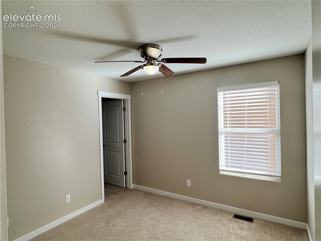 Image 22 of 42: Interior room featuring carpeted flooring, a ceiling fan with integrated li