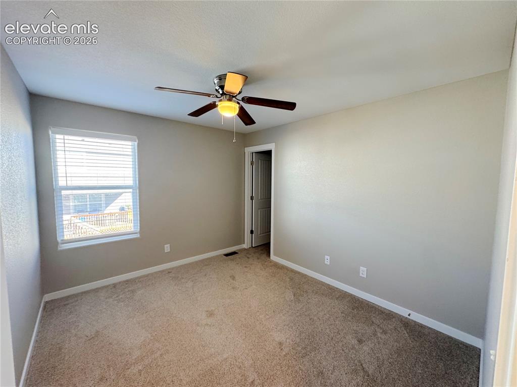 Image 24 of 42: Neutral-toned interior featuring wall-to-wall carpeting, a ceiling-mounted 