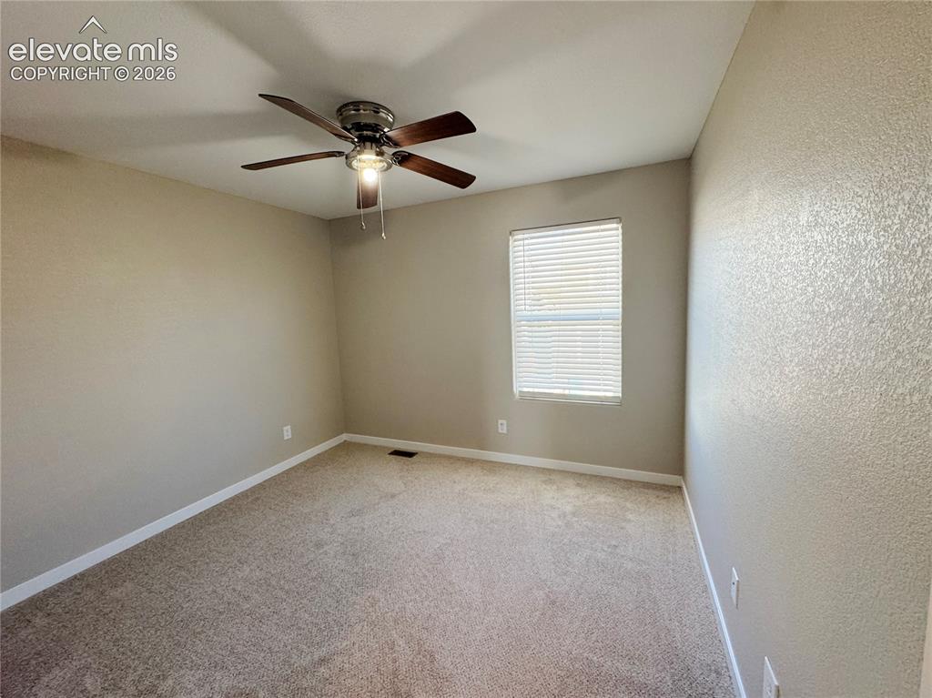 Image 26 of 42: Neutral wall tones, wall-to-wall carpeting, window with blinds, and a multi