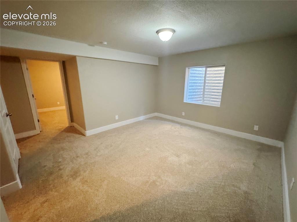 Image 35 of 42: Neutral-toned interior space featuring wall-to-wall carpeting, an inset win