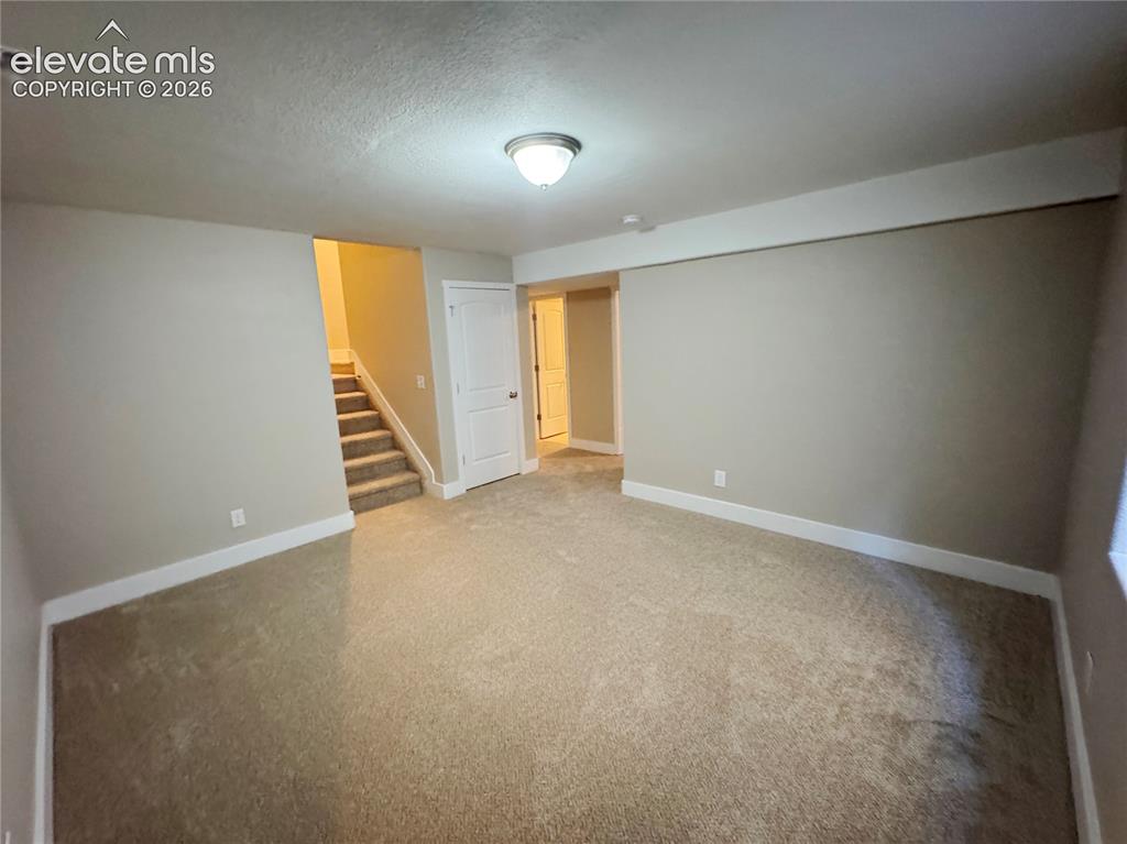 Image 36 of 42: Neutral-toned interior space featuring wall-to-wall carpeting, flush-mount 