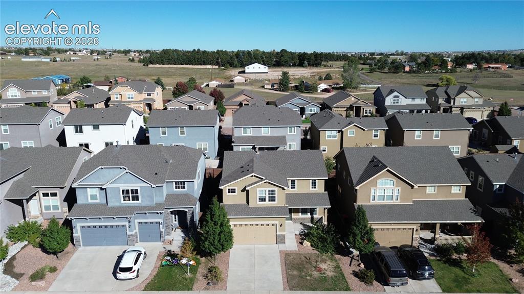 Image 5 of 42: Aerial view of a residential neighborhood featuring multi-story homes with
