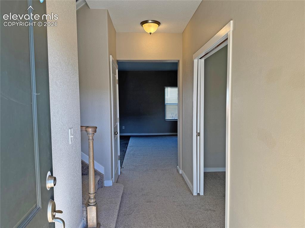 Image 7 of 42: Entryway featuring neutral wall tones, carpeted flooring, a dome-style ceil