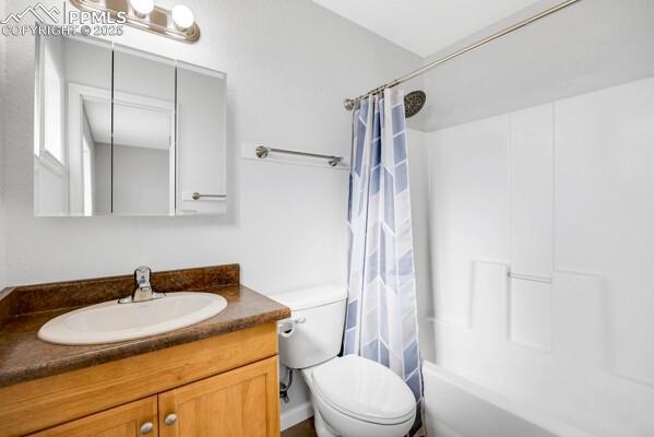 Image 15 of 26: Bathroom with shower / bath combination with curtain and vanity
