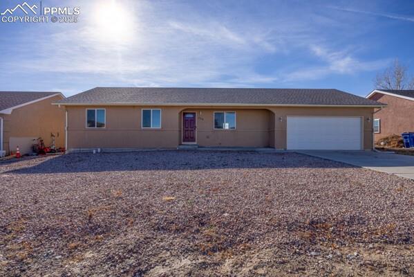 Image 2 of 26: Ranch-style home with concrete driveway and an attached garage