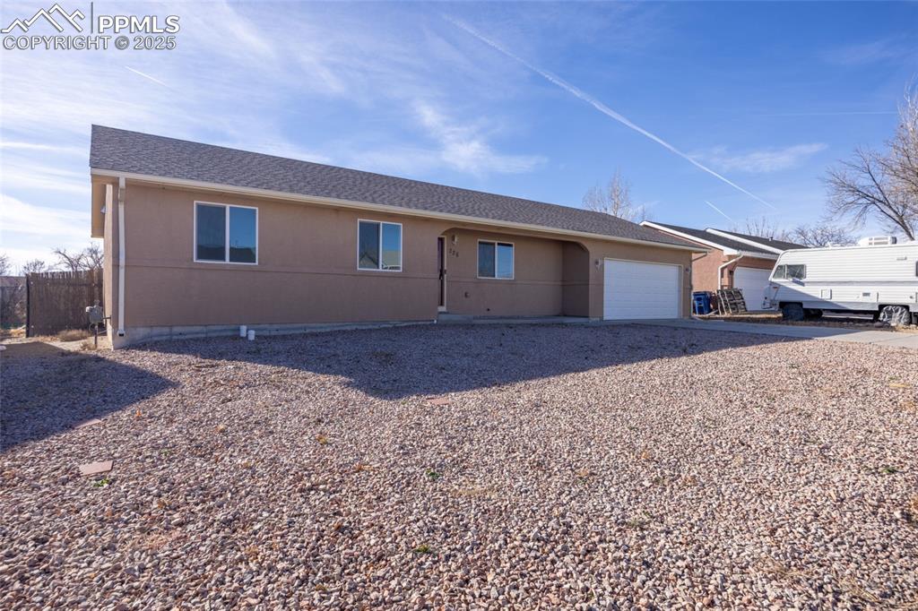 Image 3 of 26: Single story home with a garage, a shingled roof, and driveway