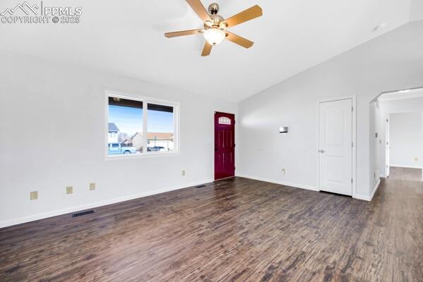 Image 4 of 26: Unfurnished living room with lofted ceiling, dark wood-style floors, a ceil