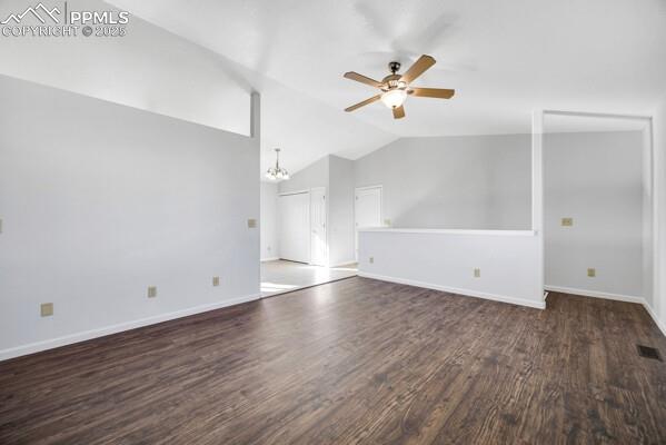 Image 5 of 26: Unfurnished living room with a chandelier, dark wood finished floors, lofte
