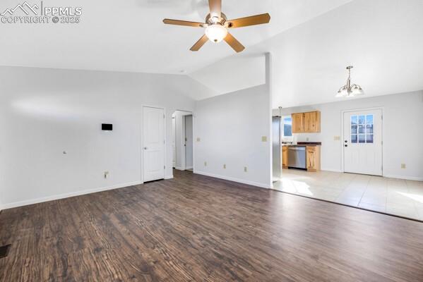 Image 6 of 26: Unfurnished living room featuring dark wood-style flooring, ceiling fan, ar