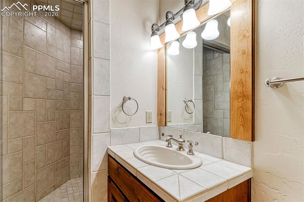 Image 27 of 50: Relaxing steam shower offering a spa-like experience in the lower level.